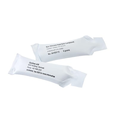 Danfoss varmeledende pasta i 6 grams tuber, en viser information om Danfoss A/S og kontaktinfo.