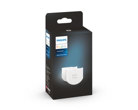Pakke med Philips Hue Wall Switch Module tilbehør, der viser et 2-pak af hvide moduler på mørk baggrund.