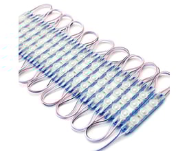 Række af LEDlife vandtætte LED moduler i blåt lys på hvid baggrund, vist fra siden med tydelige ledninger.